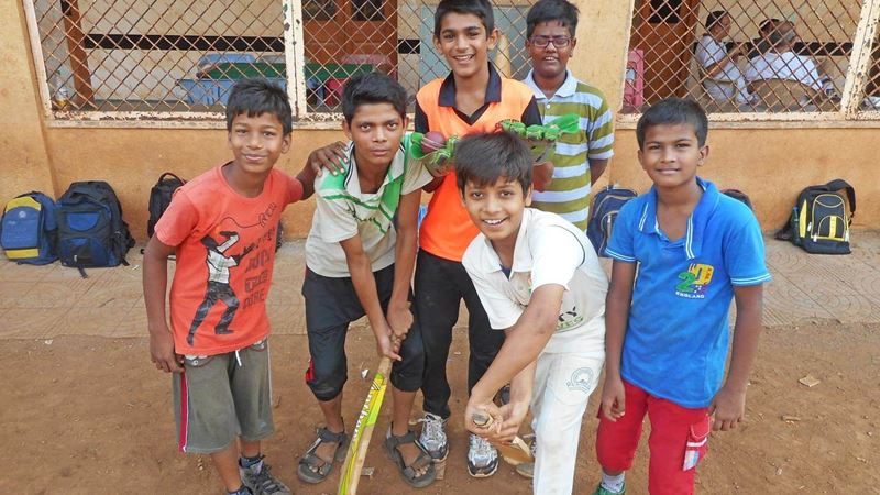 Group of young boys pretending to hit a ball