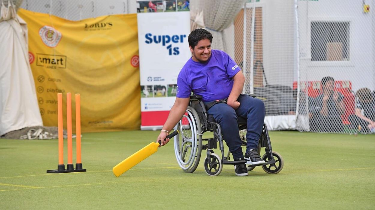Player in a wheelchair playing cricket