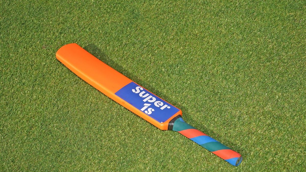 Cricket bat laying flat on the grass