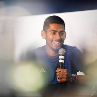 Man on the event big screen holding a microphone