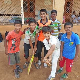 Group of young boys pretending to hit a ball