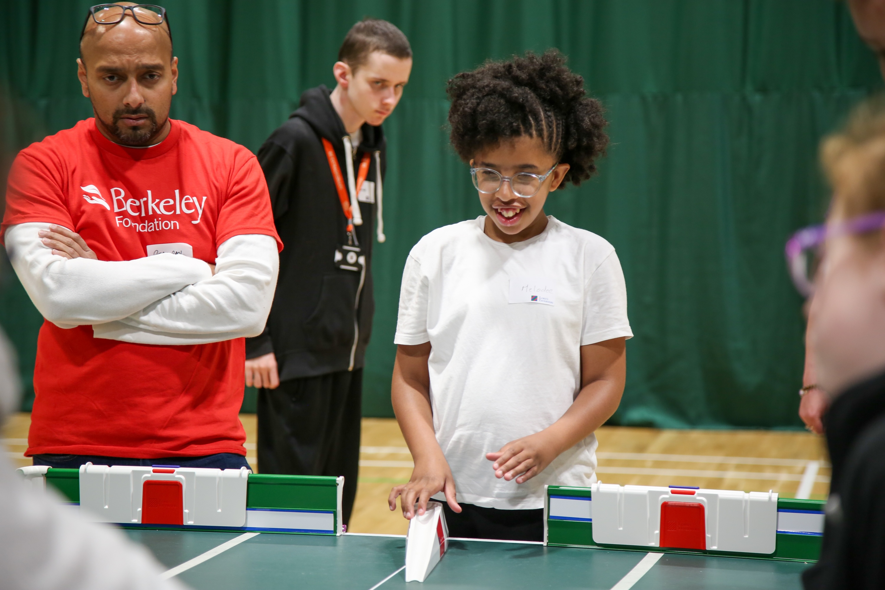 Berkeley volunteer at London & Thames Valley Regional Table Cricket Finals with young girl bowling.jpg