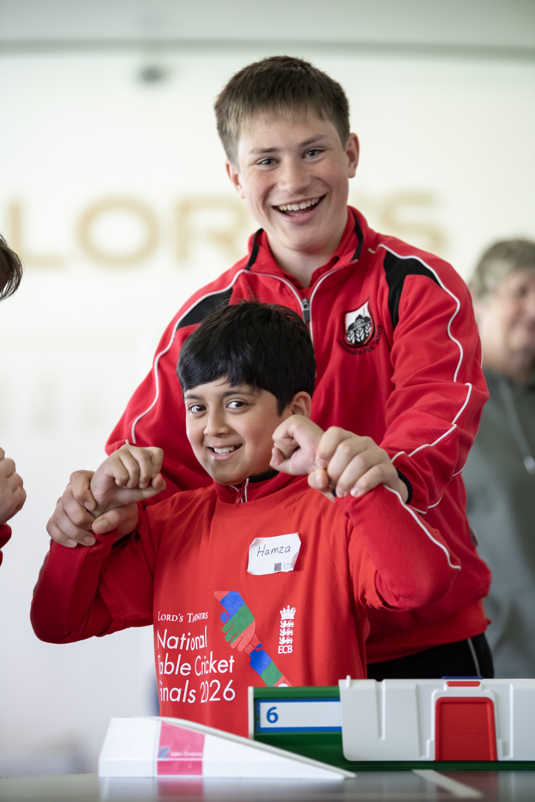 Pupils from Alexandra Park School smiling from the bowling end at Table Cricket Finals.jpeg