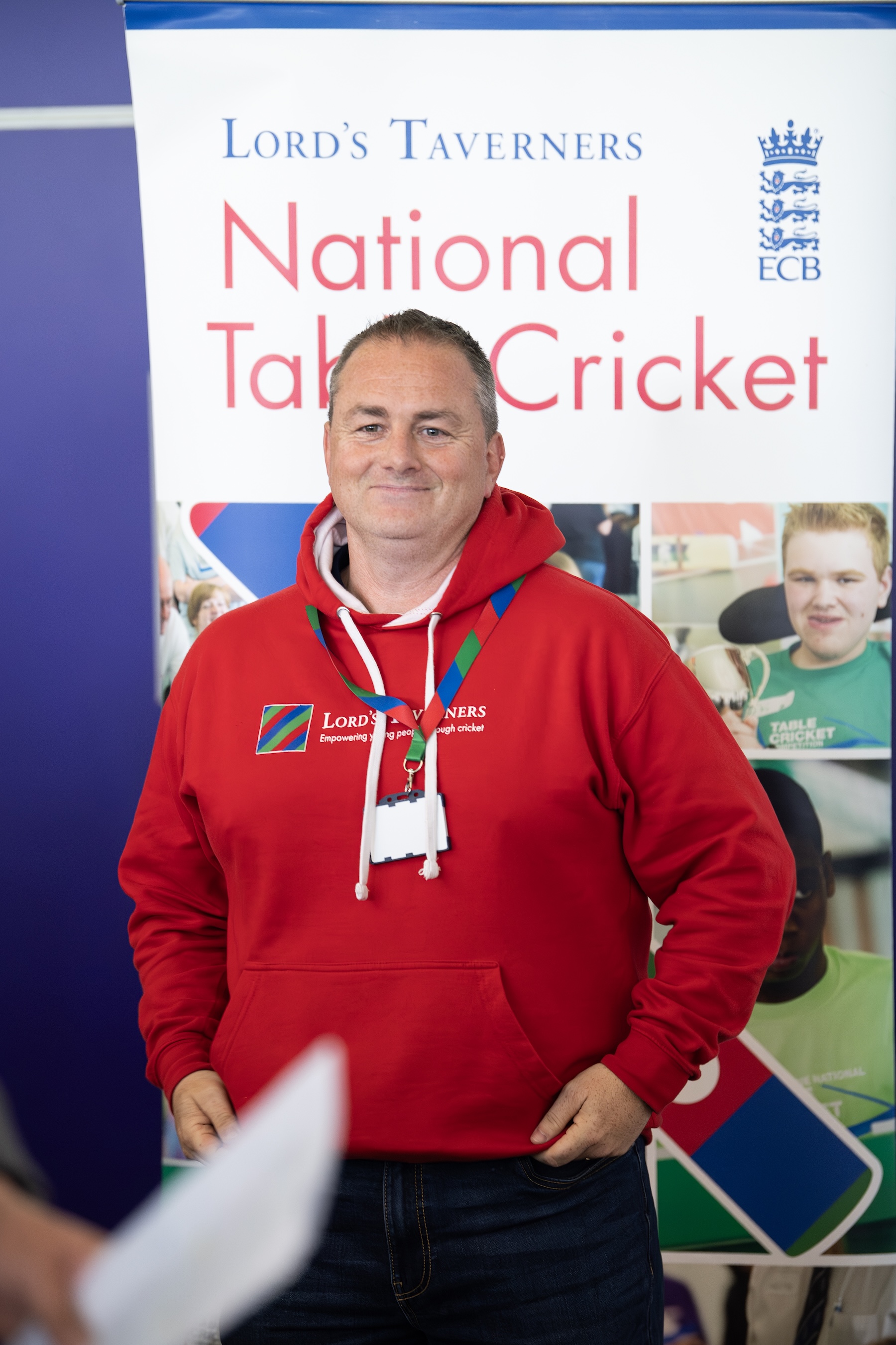 CEO Mark Curtin stood in front of a National Table Cricket roller banner.jpg