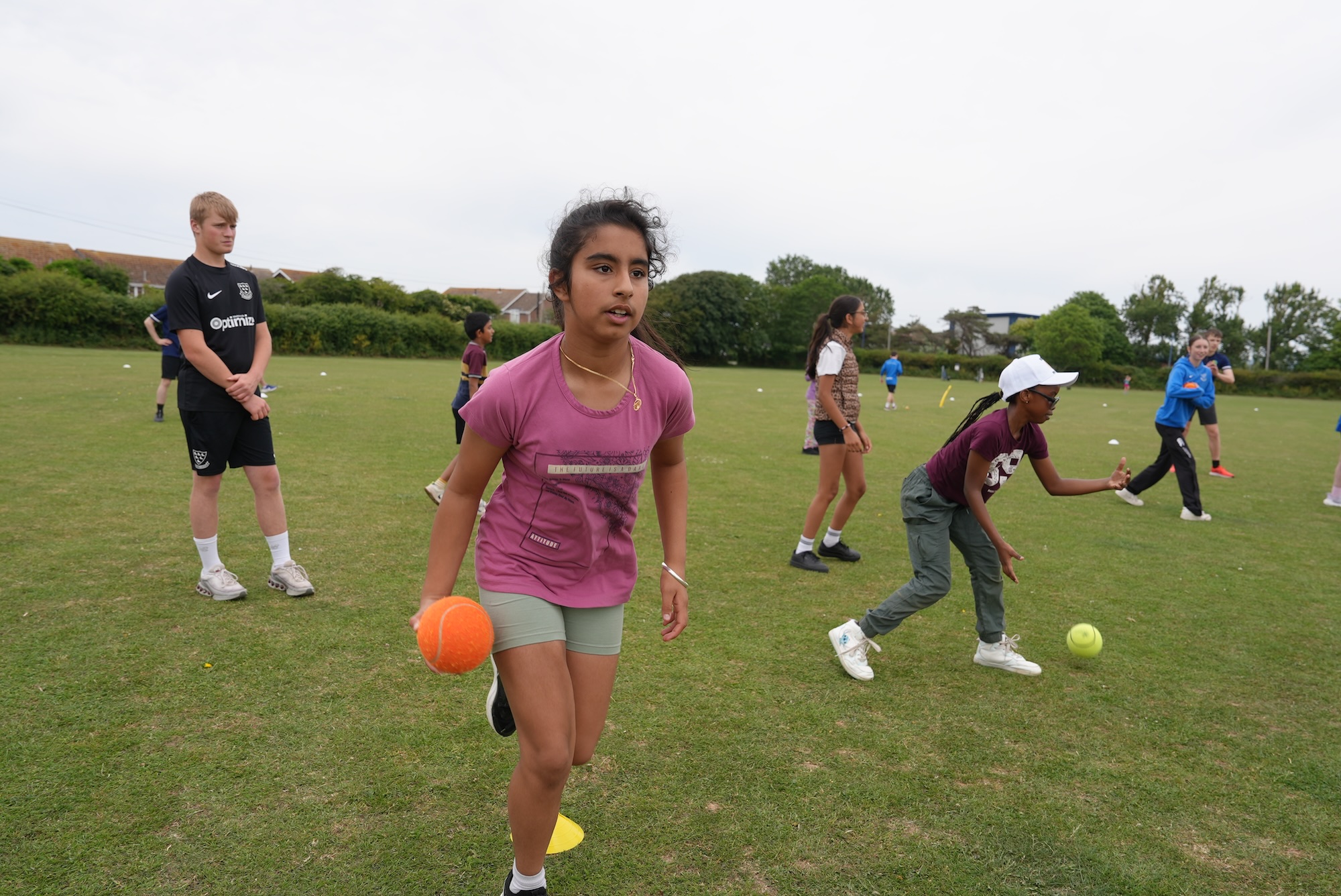 Girls throwing softballs underarm.jpg