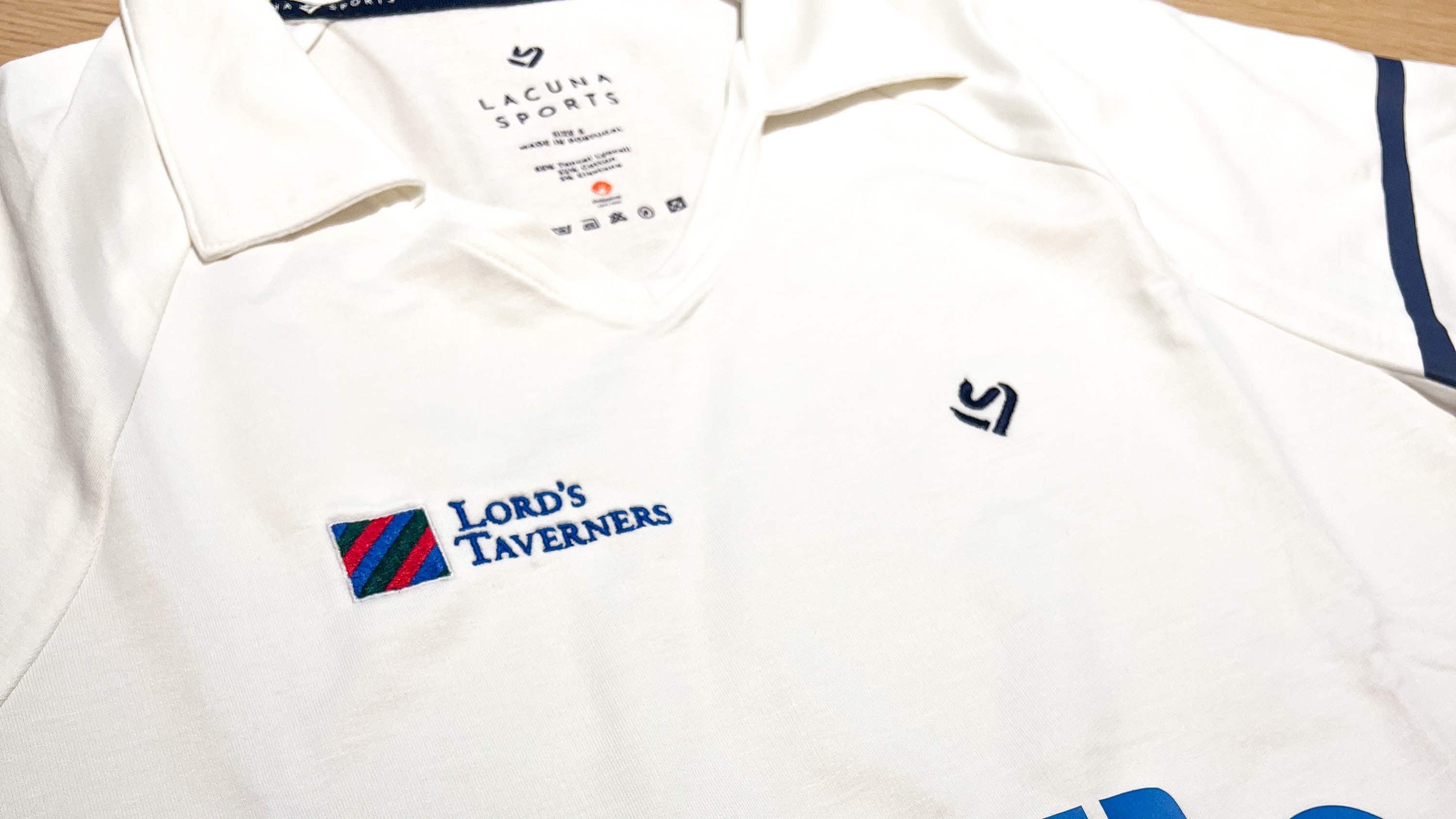 Lacuna Sports white cricket shirt with Lord's Taverners logo and LS logo on chest.jpg
