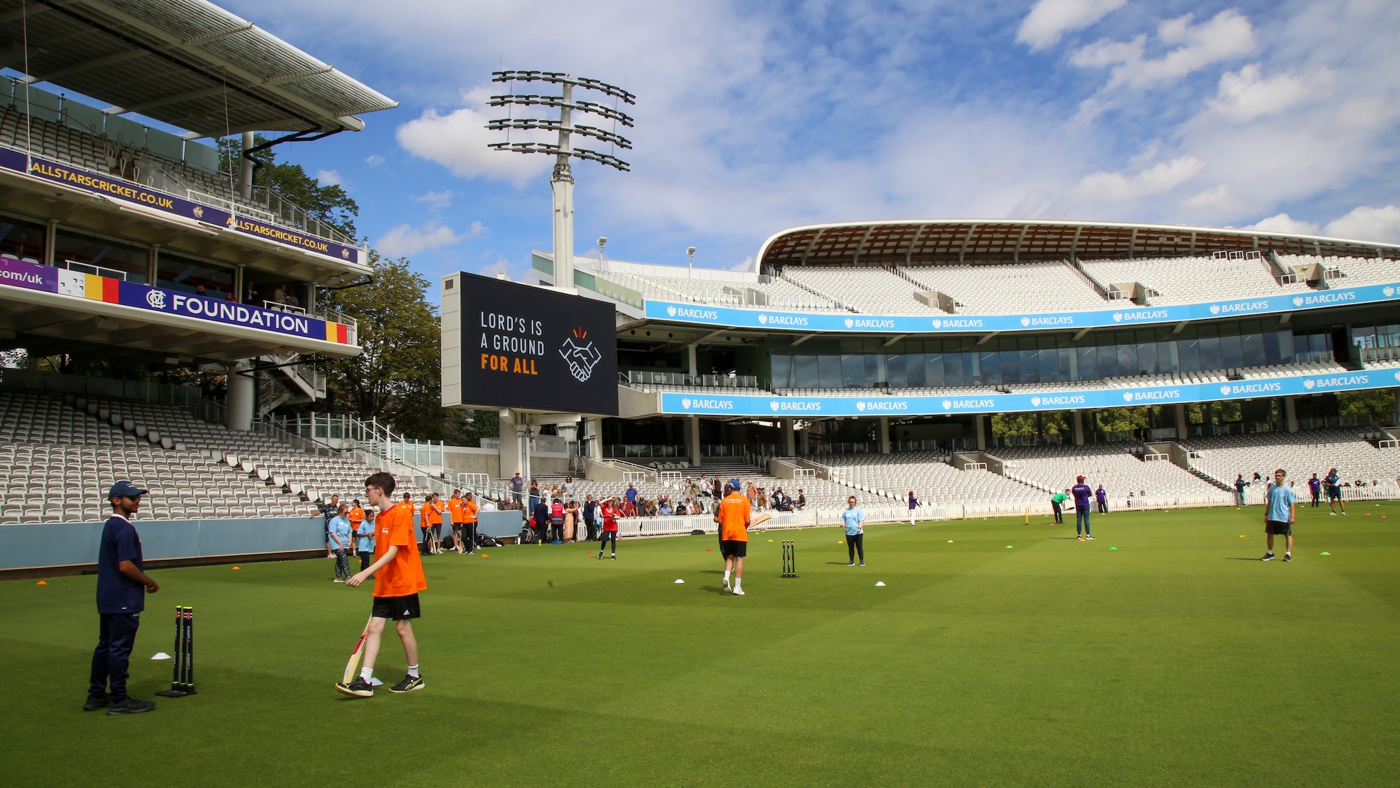 Festival of Disability Cricket - Softball cricket on the outfield at Lord's with participants, crowd in the stands.jpg