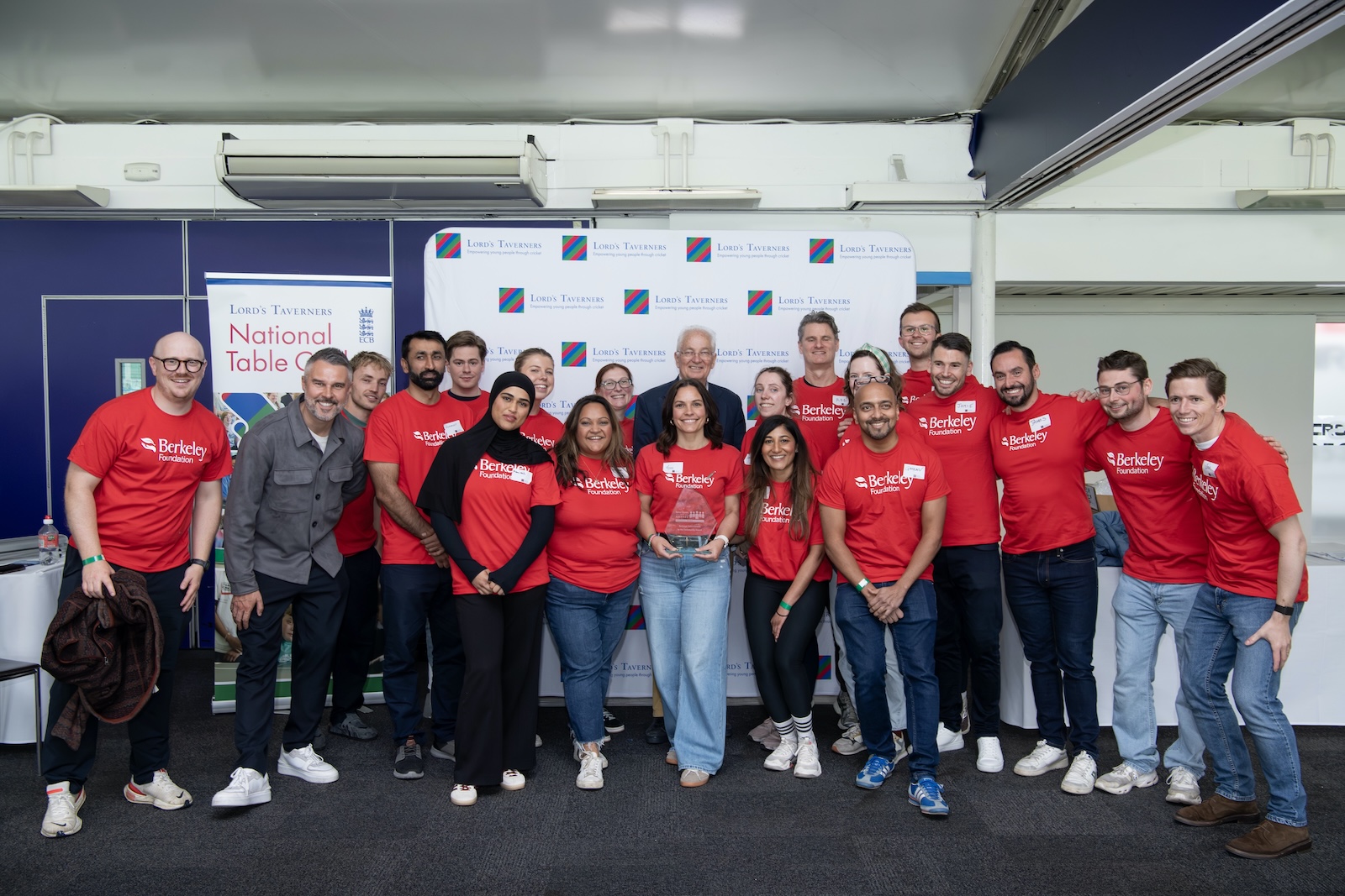 Berkeley Foundation employees in red tshirts with Pete Graves and David Gower in front of a Lord's Taverners backdrop.jpg